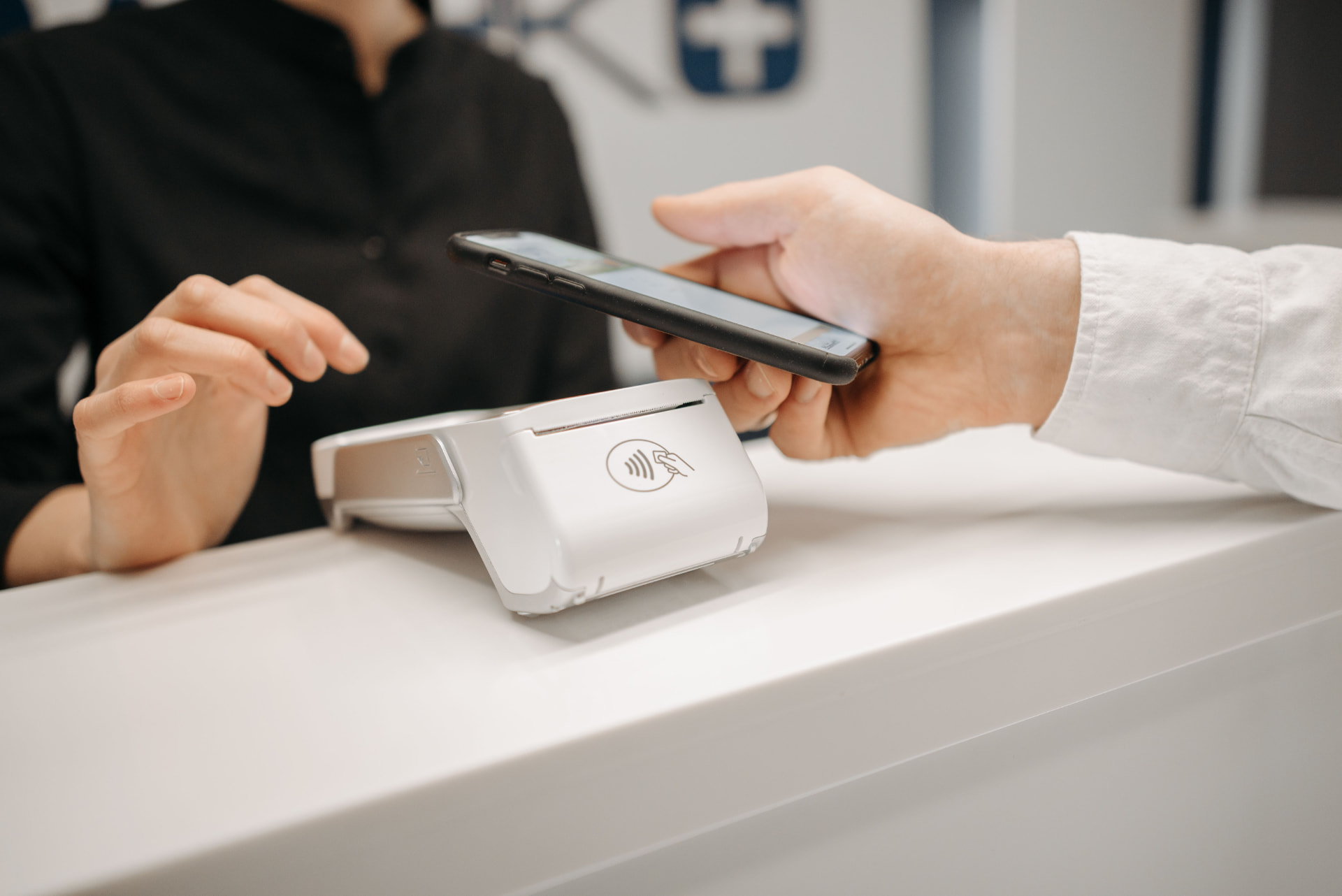 Customer making a contactless payment with a phone