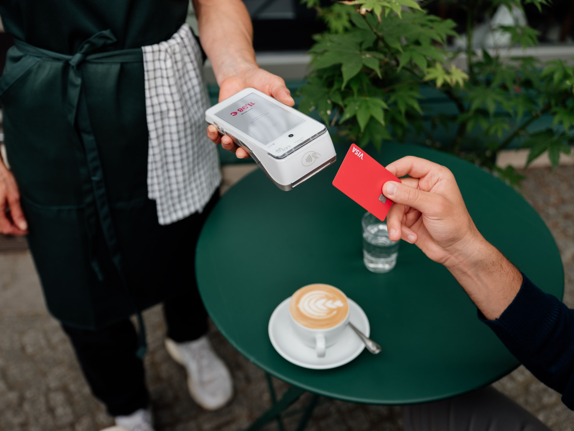 Customer making a contactless payment at a coffee shop